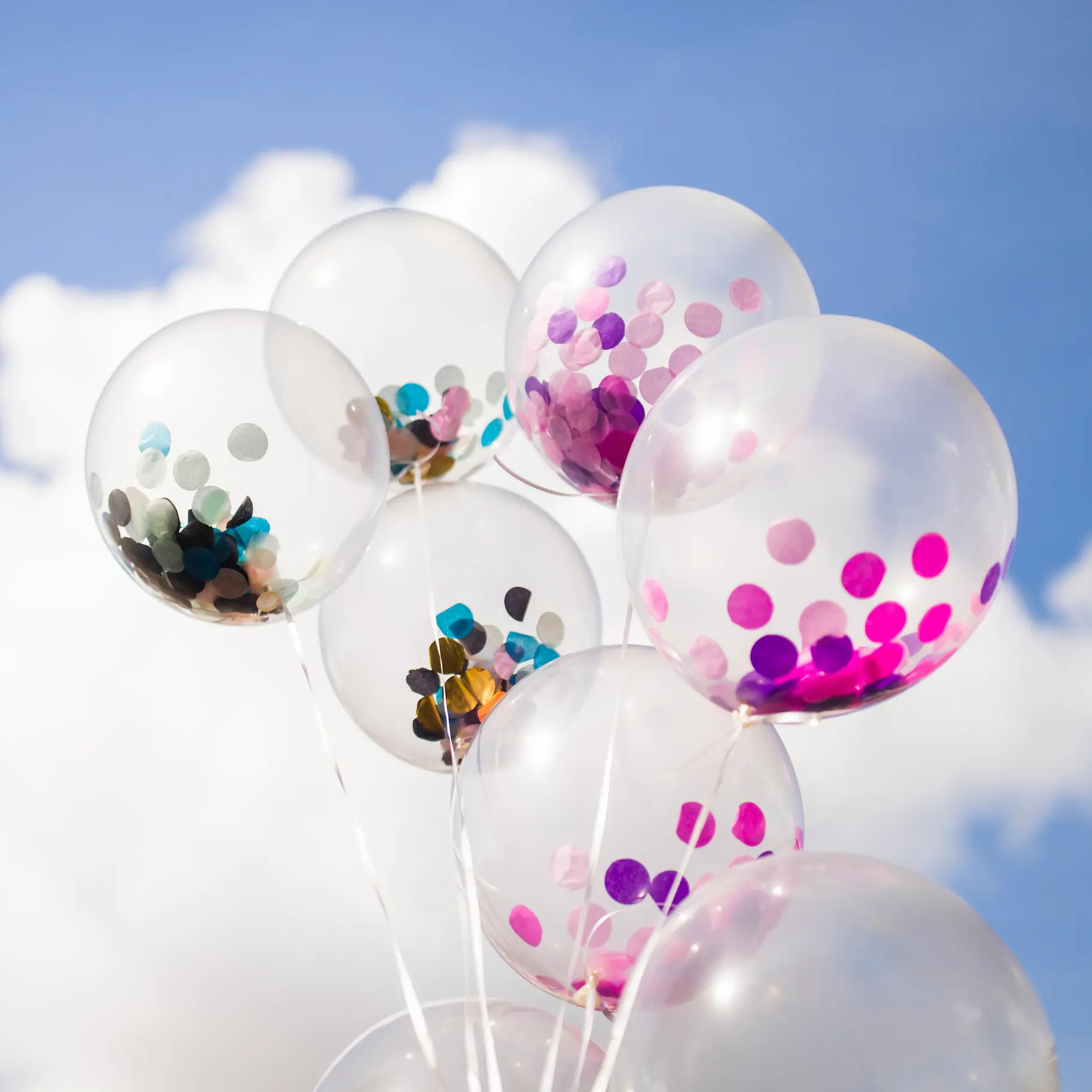 outside transparent balloons with confetti inside